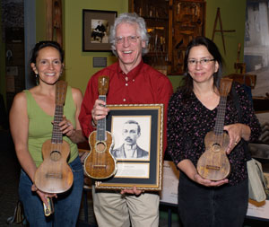 Donelle Camarillo (portrait artist), and Nuni Walsh (UHoFM) presenting Dick Boak of the Martin Guitar Company with FH Martin's inductee portrait, April, 2007