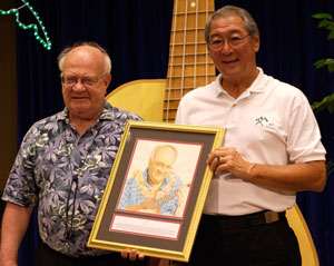 Byron Yasui presenting Lyle with his Ukulele Hall of Fame portrait at his induction ceremony at the Portland Ukulele Festival, June 2007