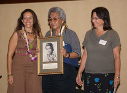 Donelle Camarillo (portrait artist), and Nuni  Walsh (UHoFM) presenting Herb Ohta with his Ukulele Hall of Fame induction portrait, November 2006